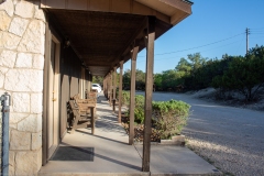 Outdoor shot of cabins, focused on wood benches.