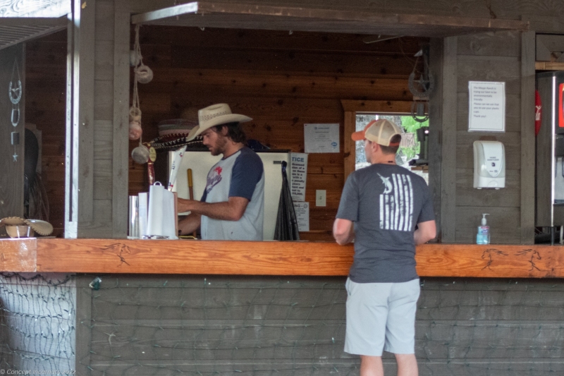 Rancher serving a drink at bar.
