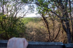 Cliff ledge overlooking hills.