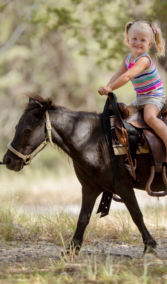 young girl riding a small horse at Mayan Dude Ranch